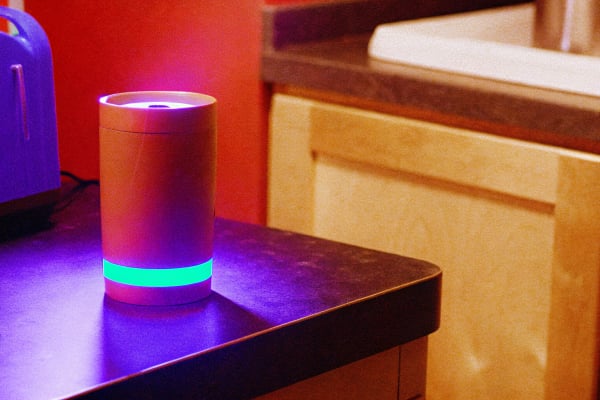 Coffee mug on a dark counter with a single mint LED clock glow, AI bookkeeping idea of the day